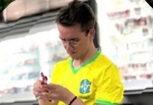 Racer in a Brazil shirt preparing his car